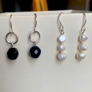Two pairs of earrings. Freshwater pearl earring. Black crystal earring.